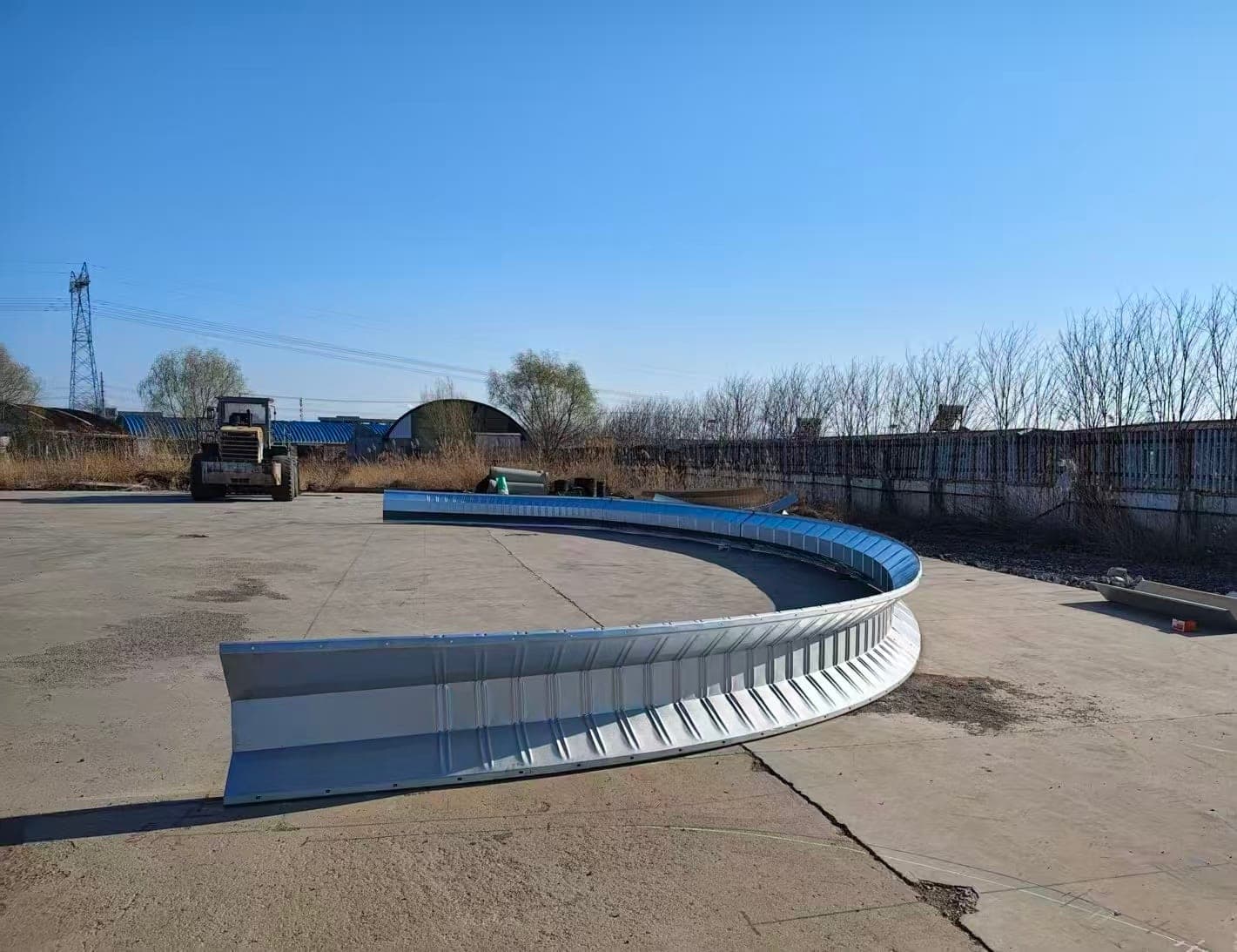 Curved arch steel building exterior with galvanized roof panels