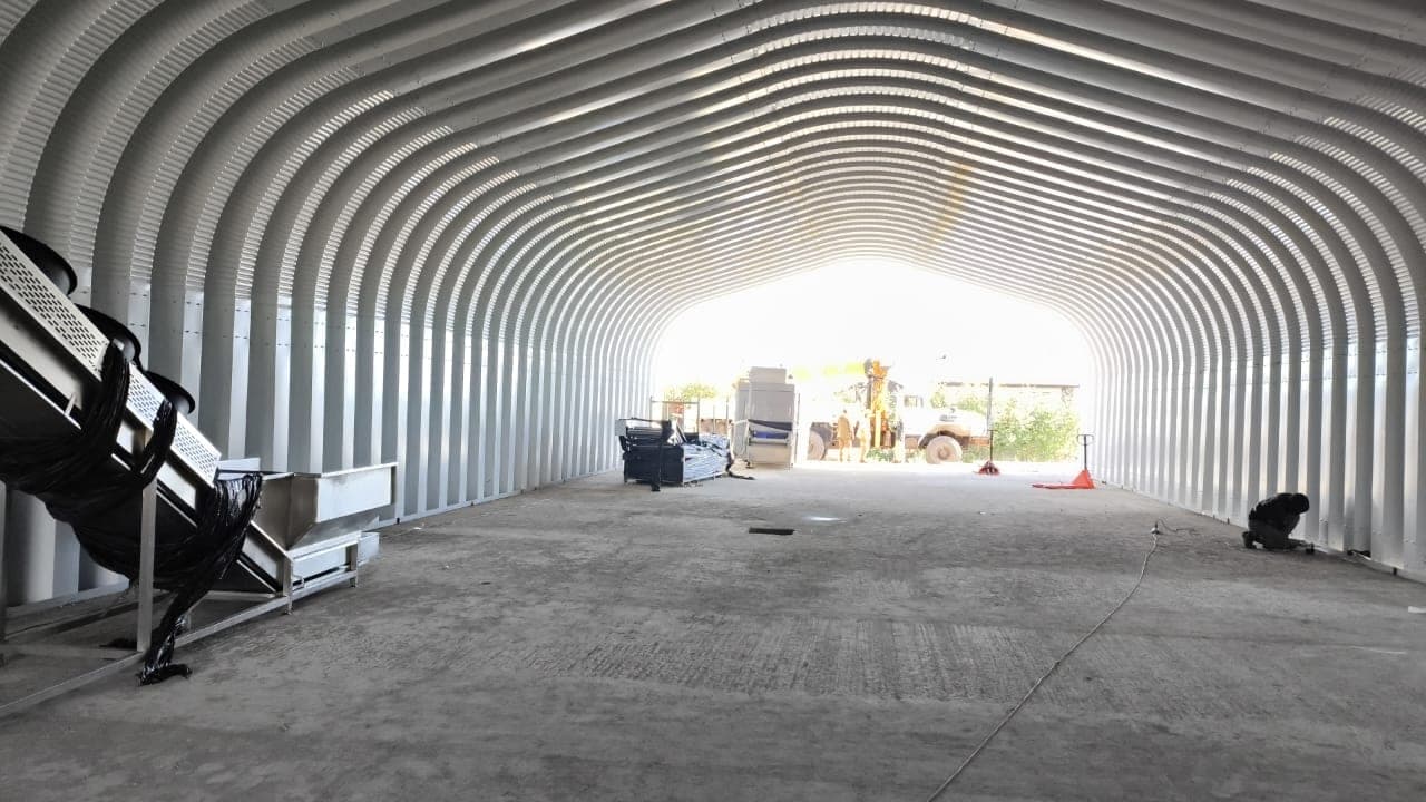 Completed steel arch building used for agricultural equipment storage